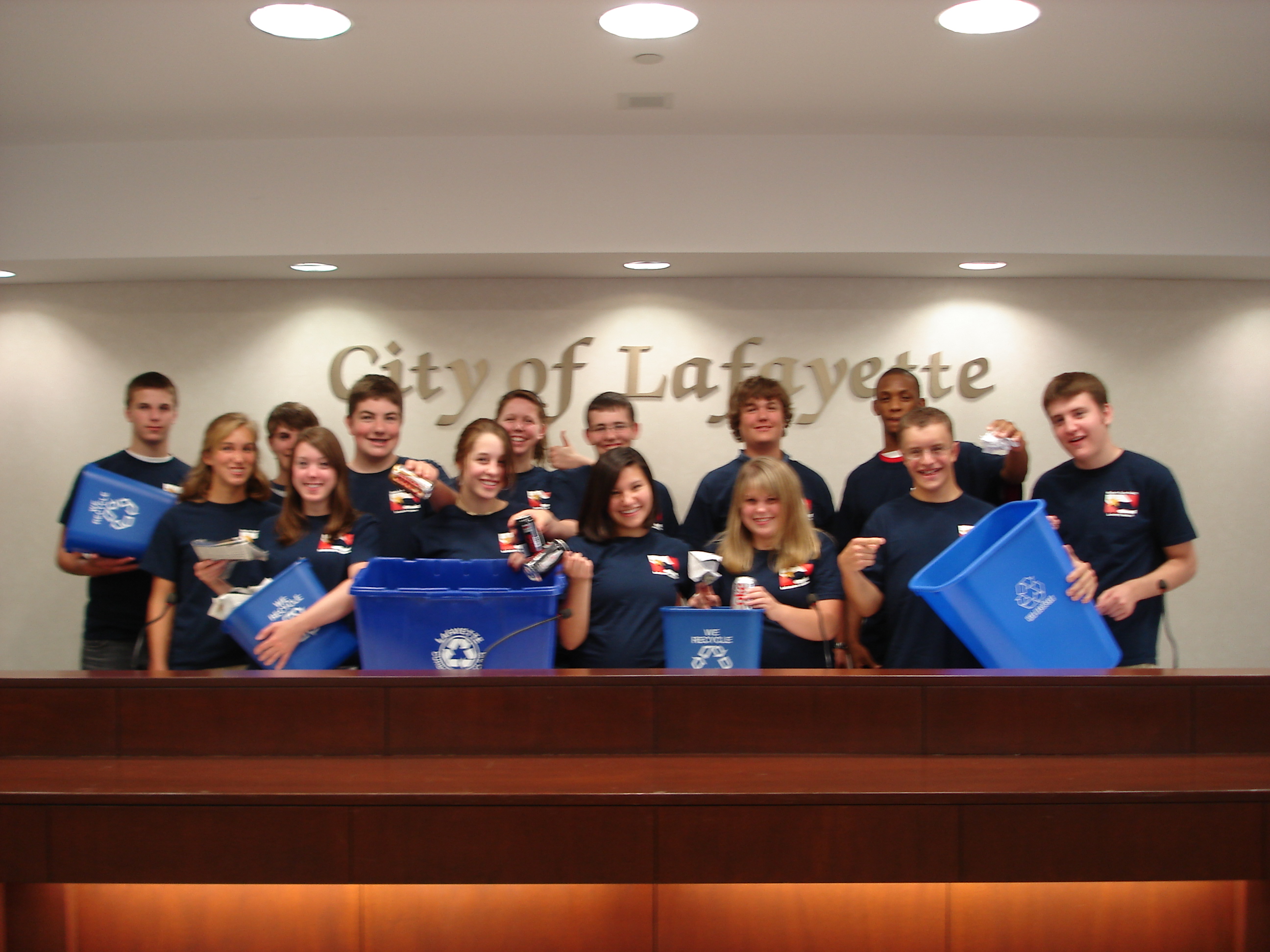 A group of teens inside City Hall with recycling bins